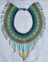 Full view of the handbeaded necklace showing geometric patterns and fringe.