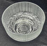 Top-down angle showing inside bottom of the glass bowl with textured circular pattern and ribbed vertical sides.