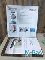 Front of box showing Whirlpool 2-in-1 stacking kit for washing machine and tumble dryer with M-Rail side rail.