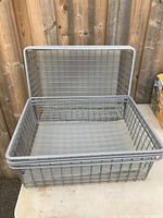 Eight IKEA metal wire baskets stacked, showing size and condition.