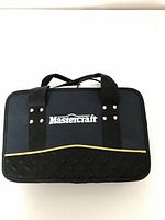 Closed fabric carrying case with Mastercraft logo and handles.