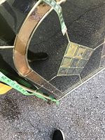 Close-up showing the corner of the stained glass panel with measuring tape showing approx 24 inches width and clear beveled and textured glass pieces in diamond shape.