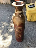 Full view of the large tall ceramic vase with natural rope tied around the neck and rustic earth-tone finish.