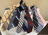 Photo of 10 men's neck ties displayed, showing various colors and patterns.