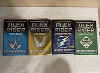 Photo showing 4 Alex Rider paperback books by Anthony Horowitz: Point Blank, Ark Angel, Stormbreaker, Skeleton Key.