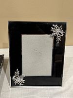 Front view of the rectangular glass photo frame. Black border with rhinestone clusters on two corners.