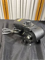 Side angle view of the black Baldor DCPM motor with right angle gearbox and power cord.