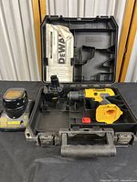 Photo of DeWalt cordless drill, charger, two batteries, instruction manual, and case, showing overall contents of the lot