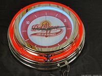Front view of Dr Pepper neon wall clock showing illuminated logo and neon rings.