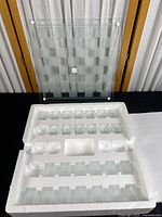 Multiple clear glass shot glasses arranged in foam packaging, showing total 22 shot glasses fitting the board slots; some slots empty as noted by seller