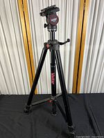 Full view of the Vivitar V5000 metal tripod showing its three extendable legs and central column.