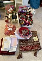 Lot overview showing Christmas table runner, bunny figurine, bows, bags, napkins, night lights