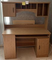 Full frontal view of wooden desk with hutch showing layout and storage compartments.