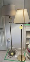 Two floor lamps standing side by side near a wall, demonstrating size and design.