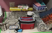 Overview of kitchen lot showing baskets, lunch bag, thermos, wrap, and towels.