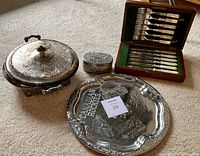 Overview of lot items: casserole dish, jewelry box, tray, flatware set