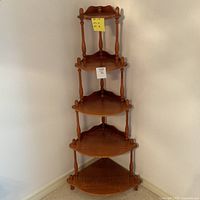 Full view of the 5-tier wooden corner shelf showing tiered shelves and turned post design.