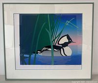 Framed limited edition print showing a stylized Hooded Merganser duck in water with tall green reeds against a blue to pink gradient background. Print is signed and numbered.
