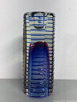 Front view of the art glass vase candleholder showing the blue striped and colored central oval design.