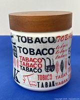 Front and side views of ceramic tobacco canister with various 'Tobacco' text and pipe graphics.
