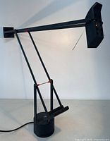 Side view of lamp showing articulated arm, base and head