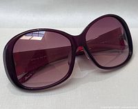 Close-up frontal view of purple Levi's sunglasses with large oval lenses