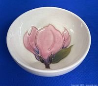 Front view of the trinket bowl showing the pink flower design inside and the crackled glaze.