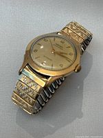 Side angle showing vintage watch with expansion band in good used condition.