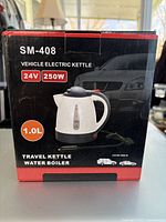 Box of SM-408 vehicle electric travel kettle showing power specifications and capacity.