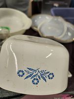 Close-up photo of white ceramic bowl showcasing blue floral pattern on bottom side.