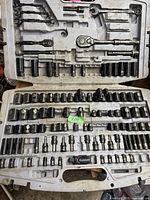 Photo of the open plastic case containing ratchets, socket extensions, and multiple sockets of various sizes and types.
