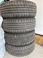 Stack of four mounted wheels showing tire tread and side profiles