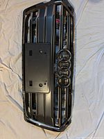 Black OEM Audi front grille with chrome surround and S5 badge, includes license plate mount
