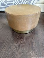 Front view of one table on hardwood floor showing overall shape and color