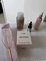 Overview of all four hair products including scalp massager, cleanser, oil, and mist