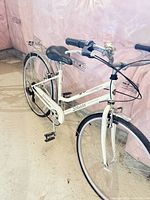 Left-side view showing full frame, chain guard, rear rack, fenders and drivetrain