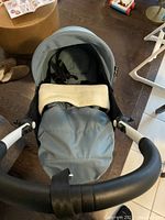 Top view of the aqua Yoyo Babyzen stroller showing the padded interior and safety harness.