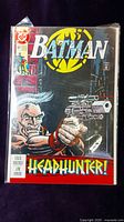 Front cover of Batman comic book issue #487 showing the 'Headhunter' storyline character with a gun and colorful background.