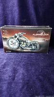 Photo of the original box of the motorcycle model clock showing the product image and details.