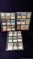 Front view of 27 Magic: The Gathering cards arranged in sets of 7, 7, and 13, showing various creatures, spells, enchantments, and artifacts.