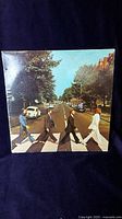 Front album cover showing the Beatles crossing Abbey Road pedestrian crossing.