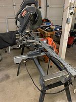 Overall view of Craftsman 10-inch compound mitre saw mounted on metal stand with ruler attachment.