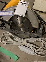 Photo showing DeWalt 7 1/4 inch circular saw with coiled power cord and inline switch.