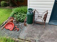 Full view of all garden items and tools arranged outdoors on ground and concrete