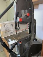 Front view of Ridgid band saw showing overall unit, blade, table, and dust hose