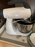 White Sunbeam stand mixer with stainless steel bowl showing stains on base