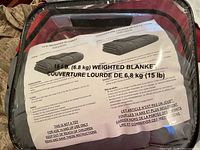 Close-up of 15 lb weighted blanket packaging with usage and safety instructions visible.