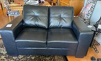 Front view of black leather sofa
