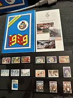 Multiple individual Aruba postage stamps laid out on black background, showing detailed designs including nature and cultural elements