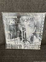 Front cover of Mauro Picotto LP showing 'AWESOME!!!' title with a passport stamp design.